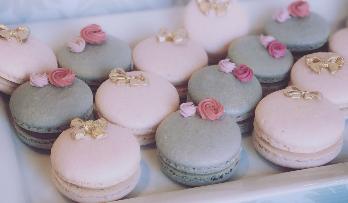 Macarons accessorized with a bow tie or rose bud