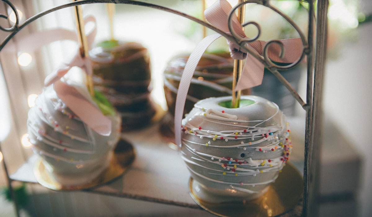 Sprinkled Candied Apples with a gold stick hung in ribbon